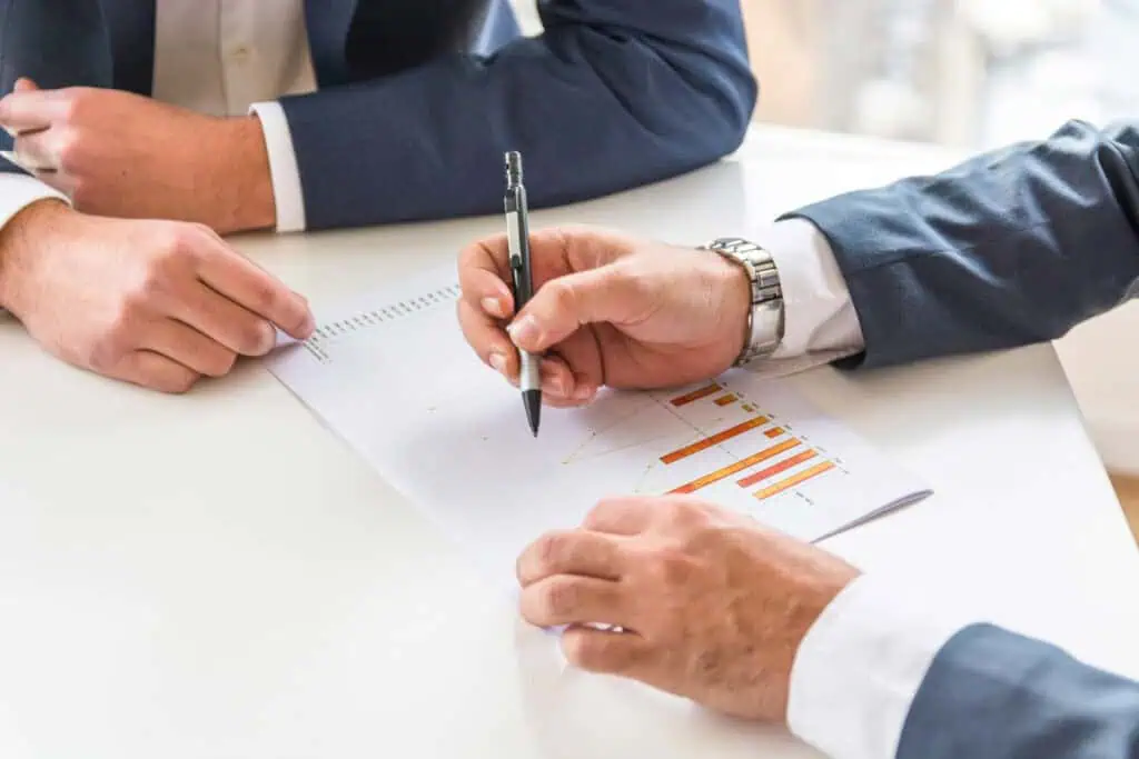two businessman analyzing the business report
