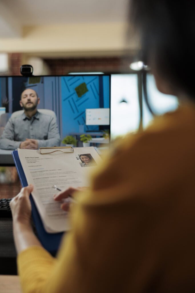 Businesswoman analyzing candidate cv discussing hiring cv with remote man during online videocall meeting. Businesspeople working at company strategy discussing partnership in office