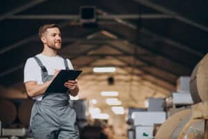Young handsome man working at a factory